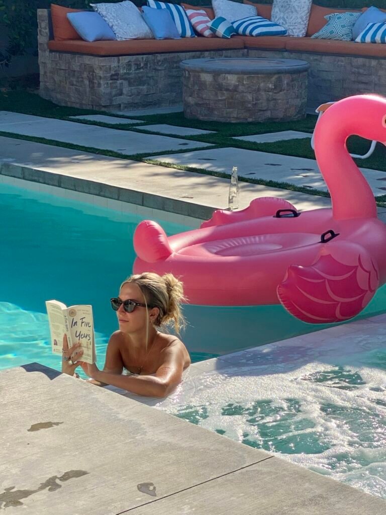 Woman enjoying quiet reading time by the pool