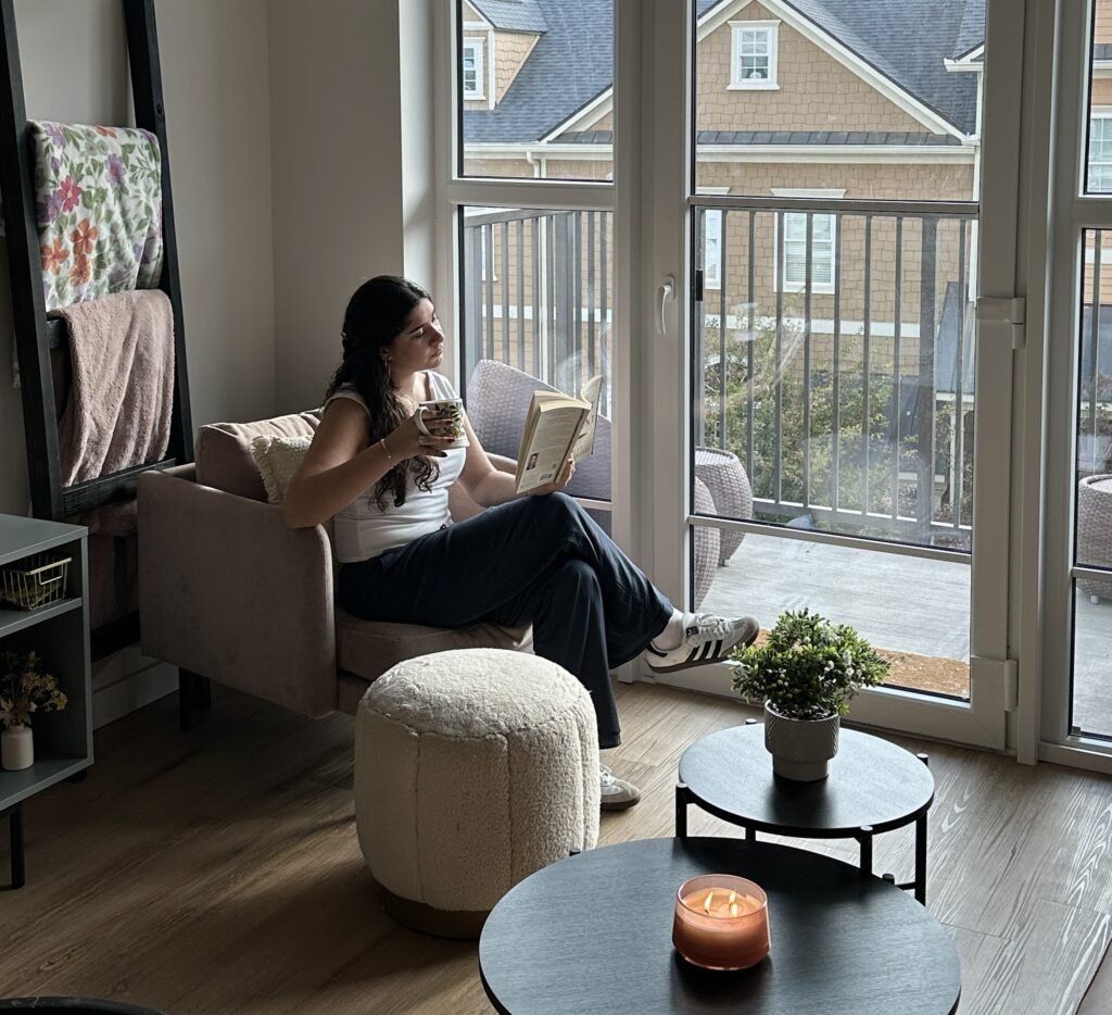 Woman reading and drinking tea at home for self-care